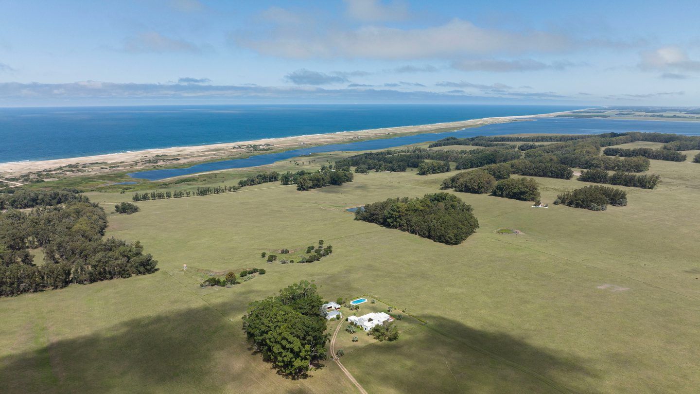 Aerial view of farmland, lagoon and ocean in Rocha