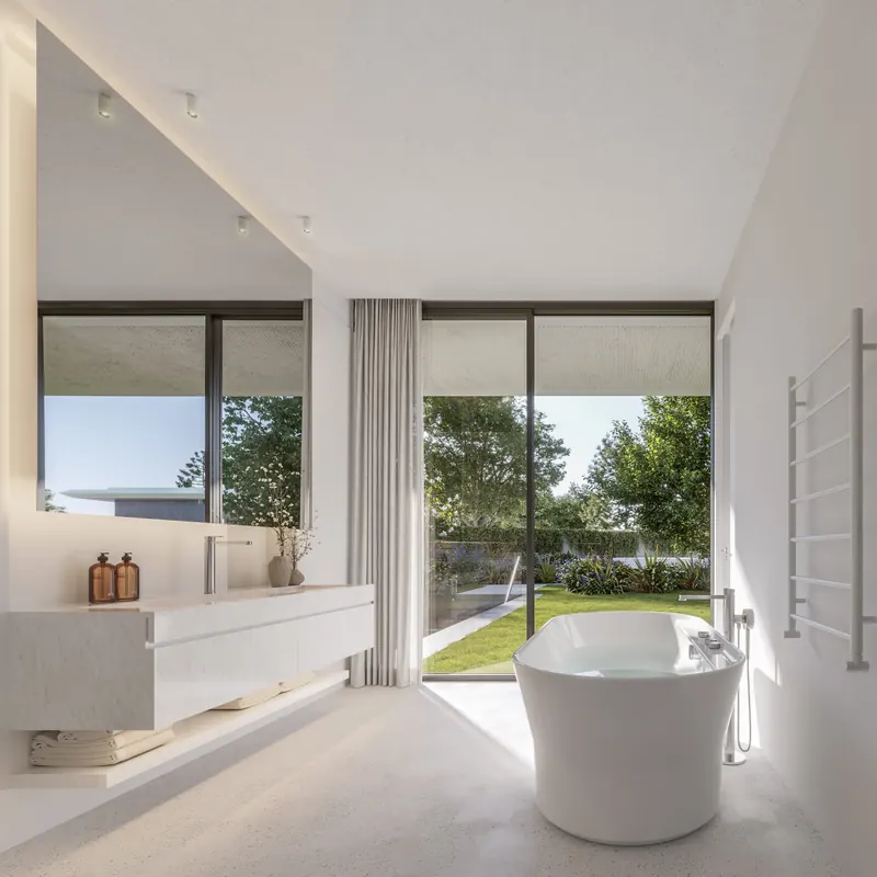 Baño con bañera y vista al jardín de la unidad 104